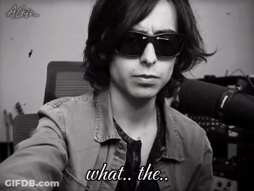 A Black And White Photo Of A Man Wearing Sunglasses With The Caption What The GIF