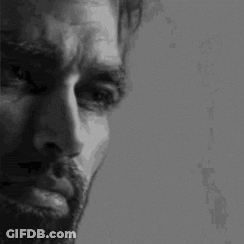 A Black And White Photo Of A Man With A Beard GIF