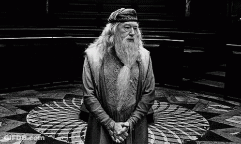 A Black And White Photo Of A Man With A Beard And A Hat Standing In A Circle . GIF