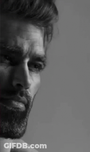 A Black And White Photo Of A Man With A Beard And A Serious Look On His Face . GIF