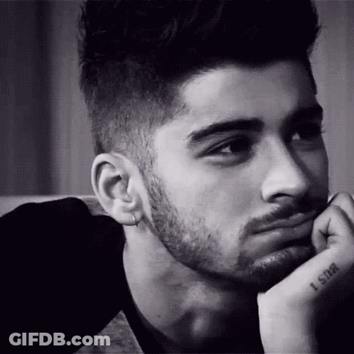 A Black And White Photo Of A Man With A Beard And Earrings . GIF