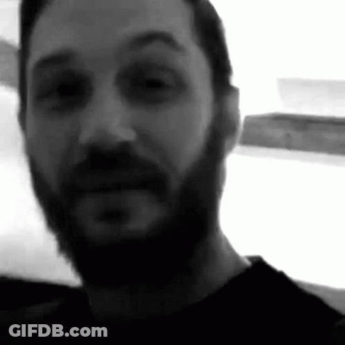 A Black And White Photo Of A Man With A Beard And Mustache . GIF