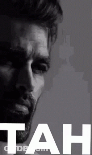 A Black And White Photo Of A Man With A Beard And The Word Tah In White Letters . GIF
