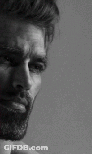 A Black And White Photo Of A Man With A Beard Looking Down . GIF