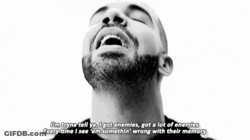 A Black And White Photo Of A Man With A Beard Making A Peace Sign With His Hands . GIF