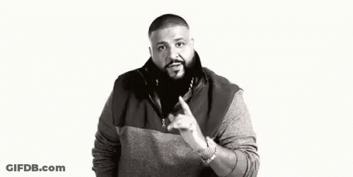 A Black And White Photo Of A Man With A Beard Pointing At Something . GIF