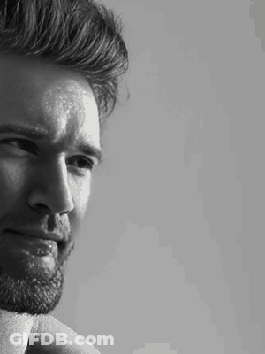 A Black And White Photo Of A Man With A Beard GIF