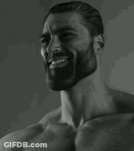 A Black And White Photo Of A Man With A Beard Smiling . GIF