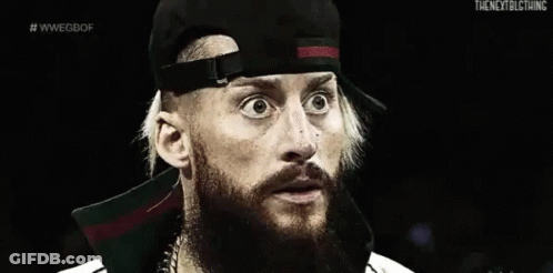 A Black And White Photo Of A Man With A Beard Wearing A Baseball Cap . GIF