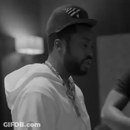 A Black And White Photo Of A Man With A Beard Wearing A Hat And Headphones . GIF