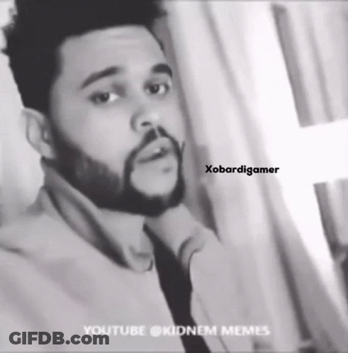 A Black And White Photo Of A Man With A Beard Wearing A Tie . GIF