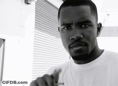 A Black And White Photo Of A Man With A Beard Wearing A White T-Shirt . GIF