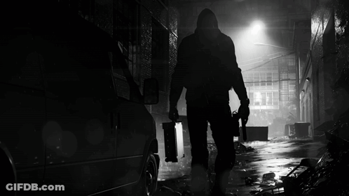 A Black And White Photo Of A Man With A Gun GIF