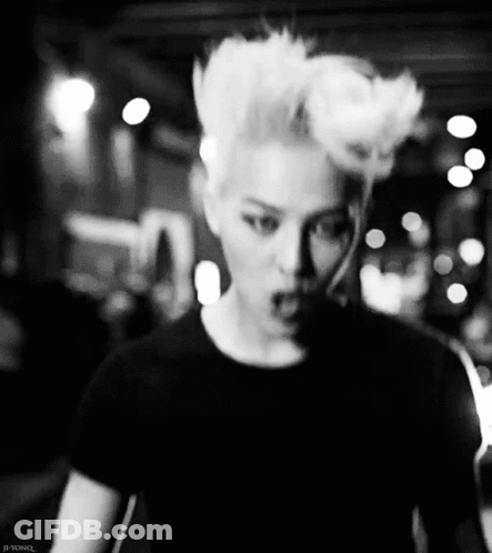 A Black And White Photo Of A Man With A Mohawk Hairstyle GIF