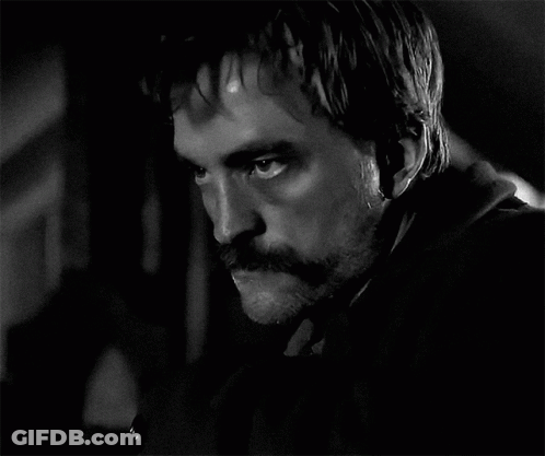 A Black And White Photo Of A Man With A Mustache And Beard GIF