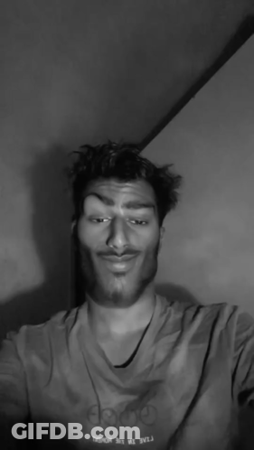 A Black And White Photo Of A Man With A Mustache Giving The Middle Finger GIF