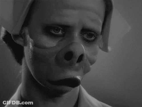 A Black And White Photo Of A Man With A Pig 'S Nose On His Face . GIF