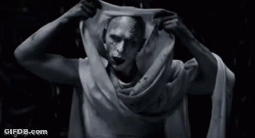 A Black And White Photo Of A Man With A Scarf Around His Neck . GIF