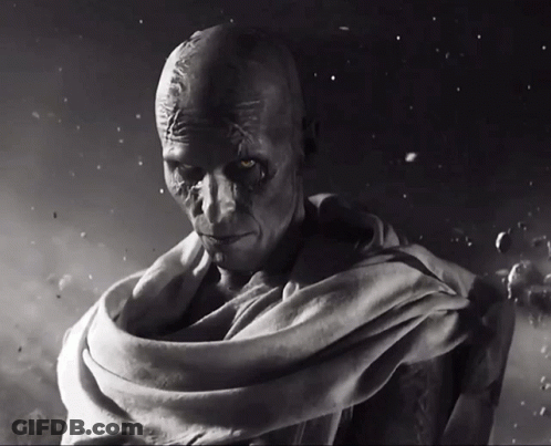 A Black And White Photo Of A Man With A Scarf Around His Waist GIF