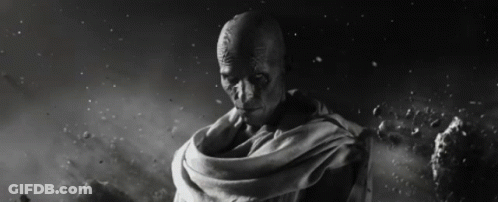 A Black And White Photo Of A Man With A Scarf Around His Waist GIF