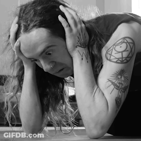 A Black And White Photo Of A Man With A Tattoo On His Arm GIF