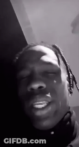 A Black And White Photo Of A Man With Dreadlocks Making A Funny Face With His Eyes Closed . GIF