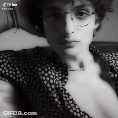 A Black And White Photo Of A Man With Glasses And A Polka Dot Shirt With Tiktok Written On The Bottom GIF