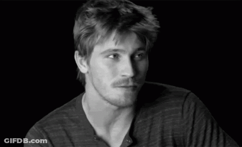 A Black And White Photo Of A Man With His Eyes Closed And His Hands Up . GIF