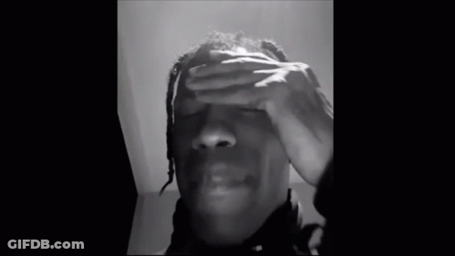 A Black And White Photo Of A Man With His Eyes Closed . GIF
