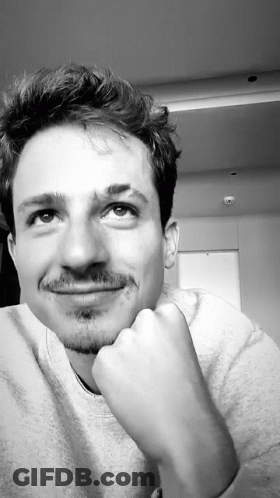 A Black And White Photo Of A Man With His Hand On His Chin Looking Up GIF