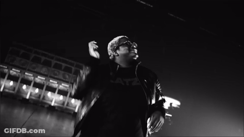A Black And White Photo Of A Man With His Hands Together GIF