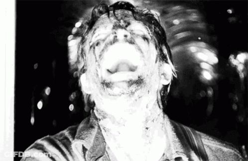 A Black And White Photo Of A Man With His Mouth Wide Open GIF