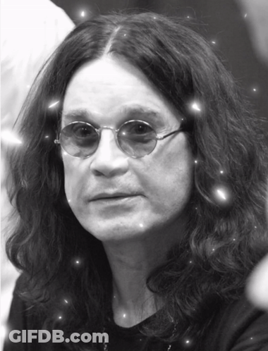 A Black And White Photo Of A Man With Long Hair And Sunglasses GIF