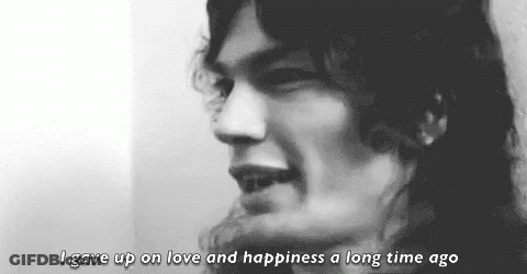 A Black And White Photo Of A Man With Long Hair And The Words `` I Gave Up On Love And Happiness A Long Time Ago '' GIF