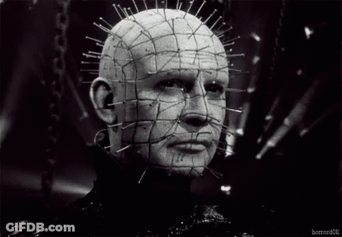 A Black And White Photo Of A Man With Pins In His Head GIF