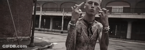 A Black And White Photo Of A Man With Tattoos Giving The Middle Finger . GIF