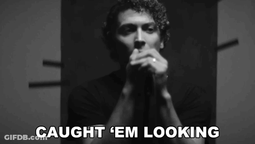 A Black And White Photo Of A Man With The Words Caught ' Em Looking ' On The Bottom GIF