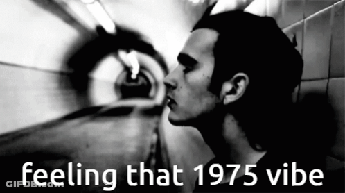 A Black And White Photo Of A Man With The Words Feeling That 1975 Vibe Above Him GIF
