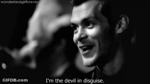 A Black And White Photo Of A Man With The Words " I 'M The Devil In Disguise " GIF