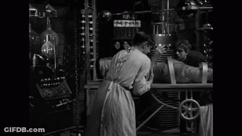 A Black And White Photo Of A Man With The Words It 'S Alive Behind Him GIF