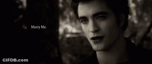 A Black And White Photo Of A Man With The Words Marry Me Written Above Him GIF