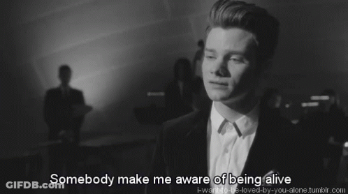 A Black And White Photo Of A Man With The Words Somebody Make Me Aware Of Being Alive Below Him GIF
