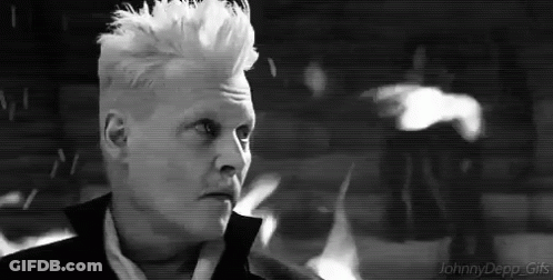 A Black And White Photo Of A Man With White Hair And A Mohawk . GIF