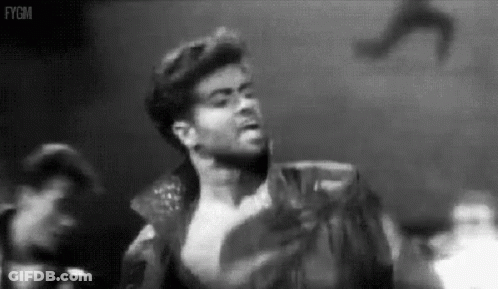 A Black And White Photo Of A Man Without A Shirt On A Stage . GIF