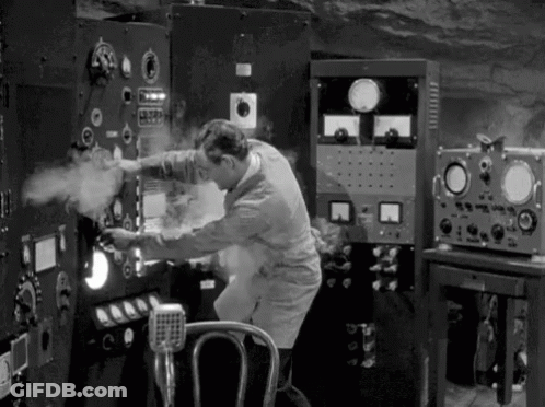 A Black And White Photo Of A Man Working On A Machine In A Room . GIF