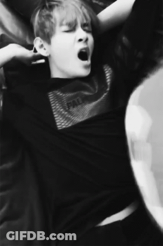 A Black And White Photo Of A Man Yawning GIF