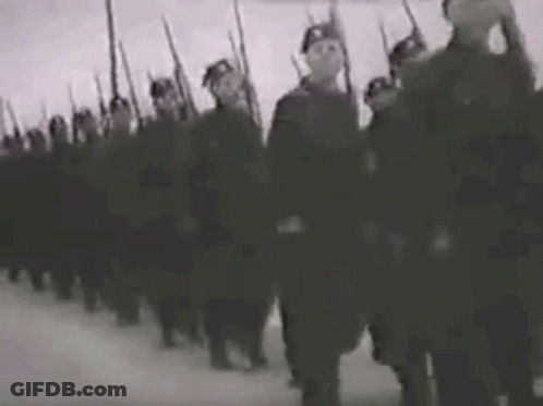 A Black And White Photo Of A Military Parade With Soldiers Marching In A Line . GIF