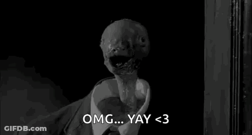 A Black And White Photo Of A Monster In A Suit And Tie Saying Omg ... Yay < 3 . GIF