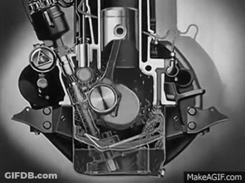 A Black And White Photo Of A Motorcycle Engine With Water Coming Out Of It . GIF