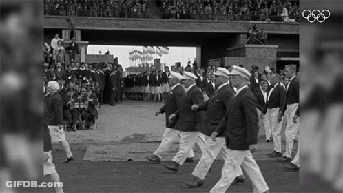 A Black And White Photo Of A Parade With The Olympics Logo On The Bottom GIF